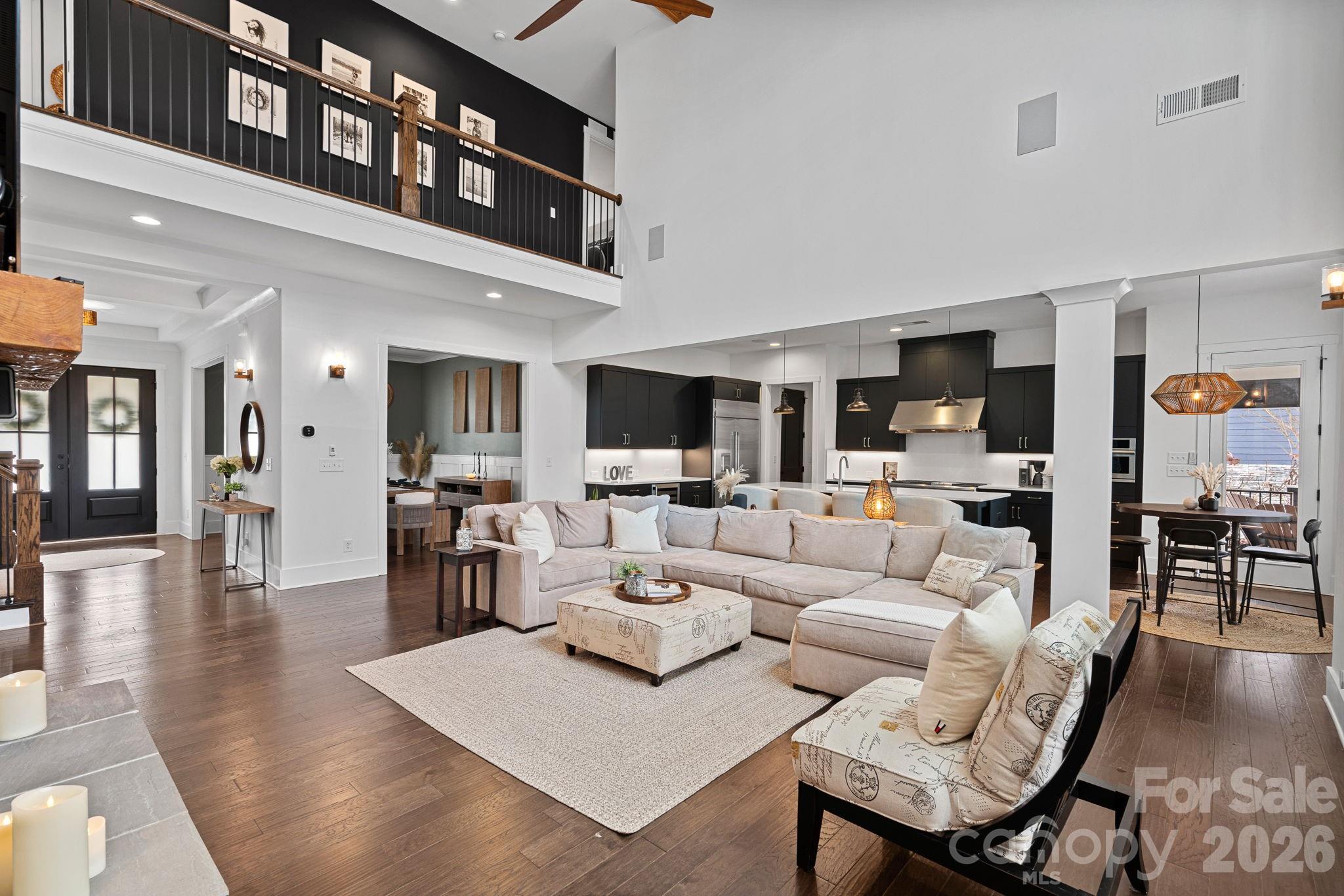 18401 Doves Crest Road Cornelius, NC 28031 - Photo 12 of 39 a living room with furniture wooden floor and a flat screen tv