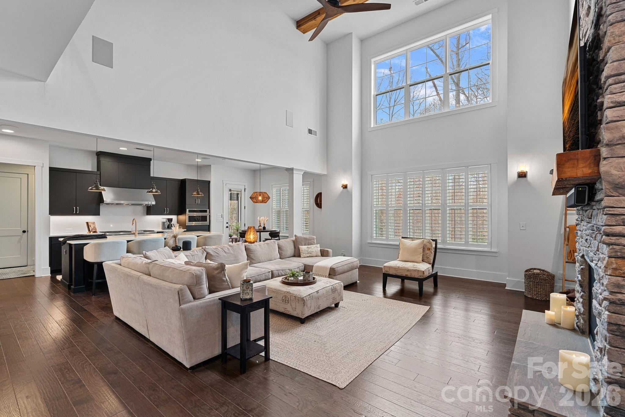 18401 Doves Crest Road Cornelius, NC 28031 - Photo 13 of 39 a living room with furniture floor to ceiling window and a flat screen tv