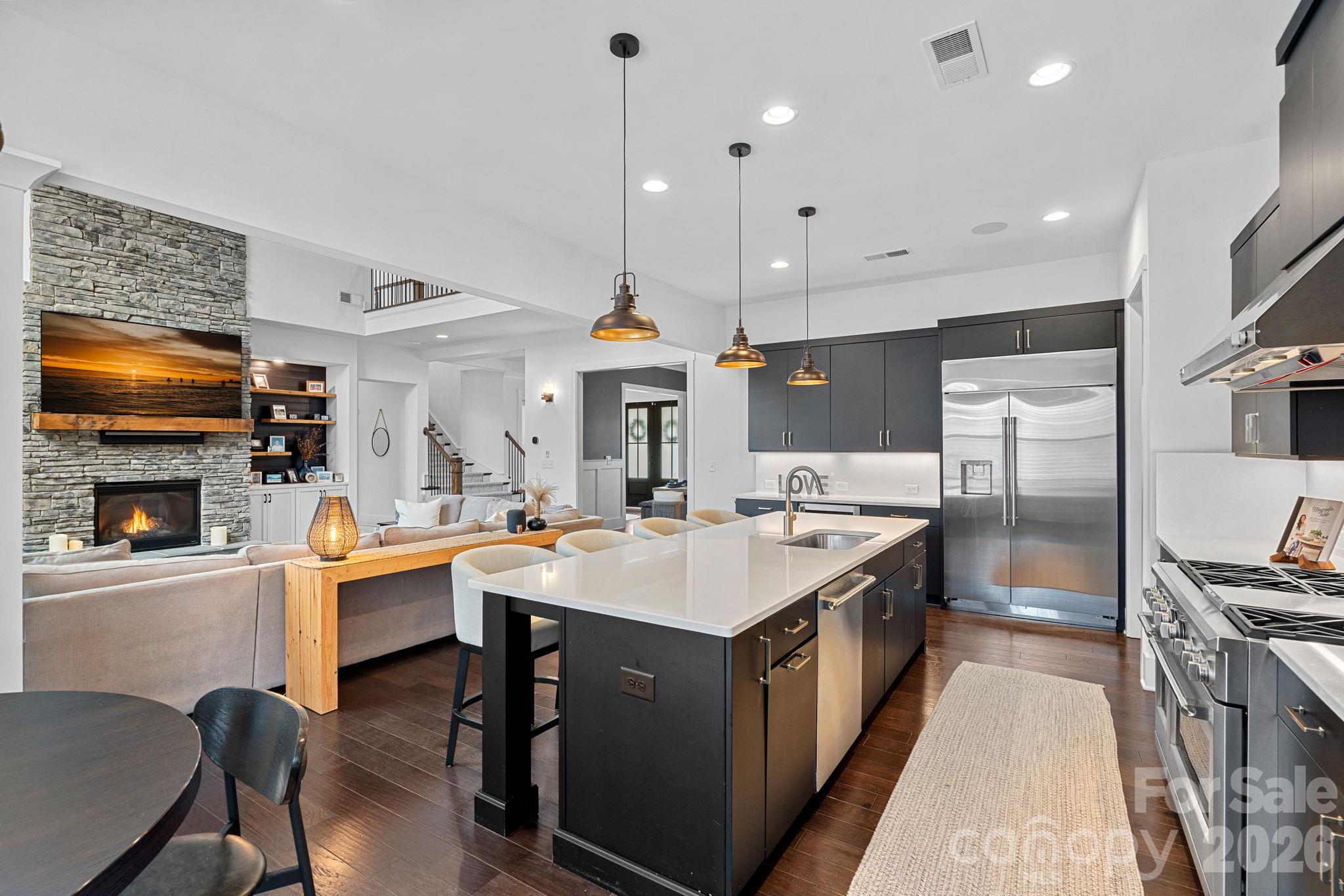 18401 Doves Crest Road Cornelius, NC 28031 - Photo 14 of 39 a open kitchen with stainless steel appliances granite countertop a sink a stove and a refrigerator
