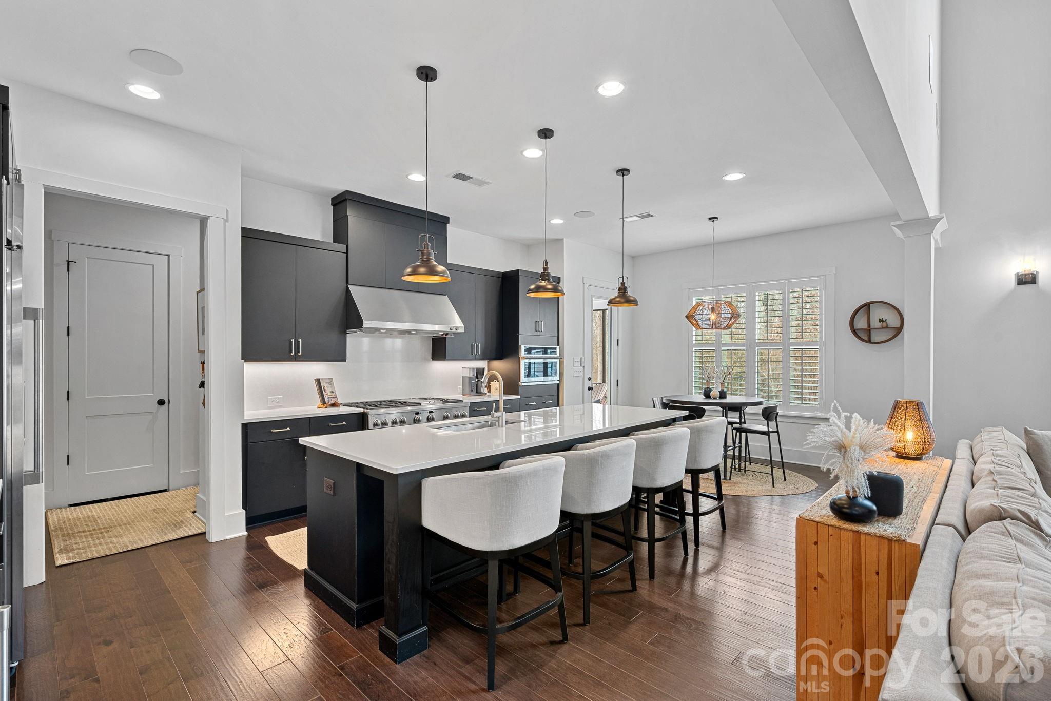 18401 Doves Crest Road Cornelius, NC 28031 - Photo 15 of 39 a large kitchen with a table and chairs