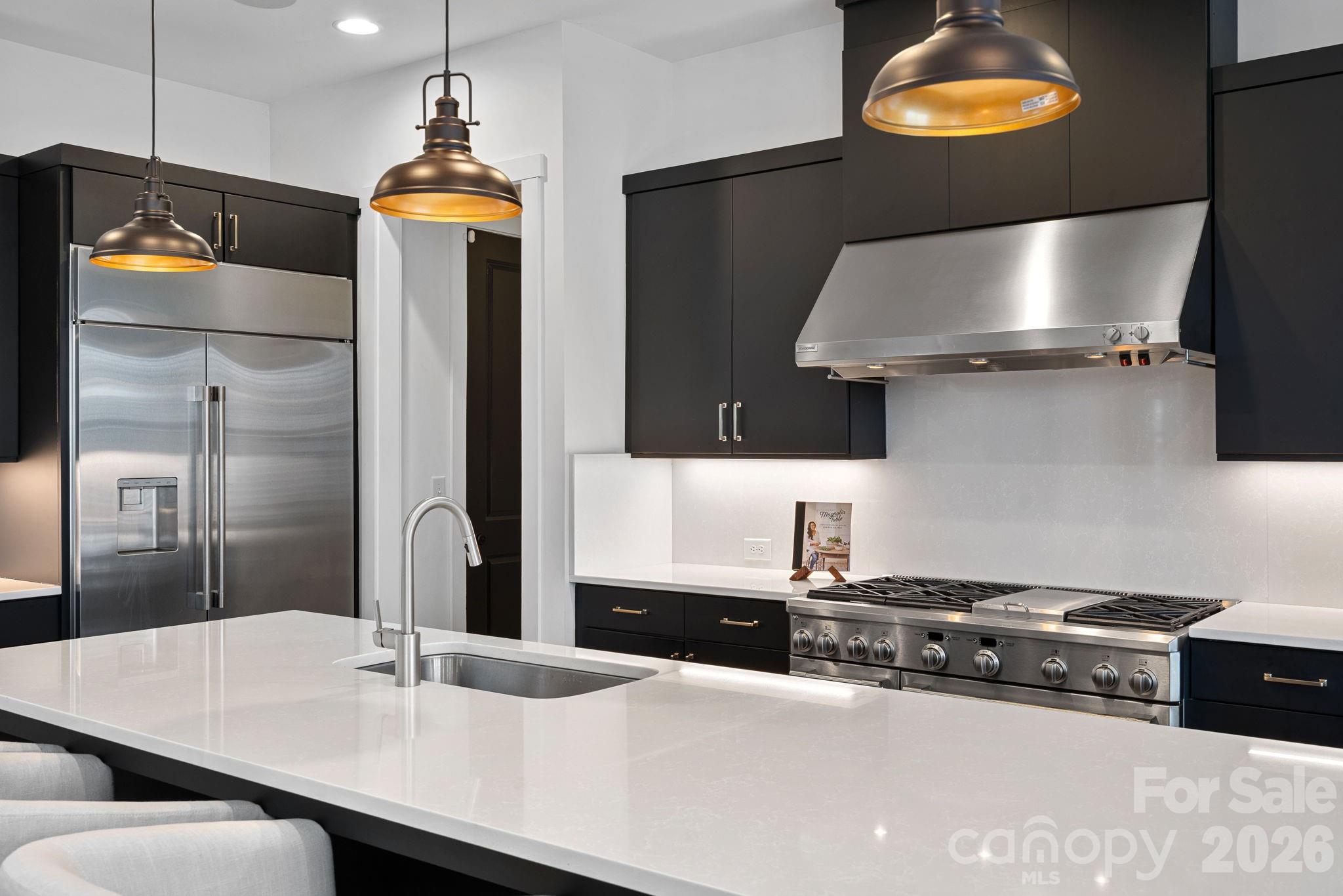 18401 Doves Crest Road Cornelius, NC 28031 - Photo 17 of 39 a kitchen with stainless steel appliances a sink and a refrigerator