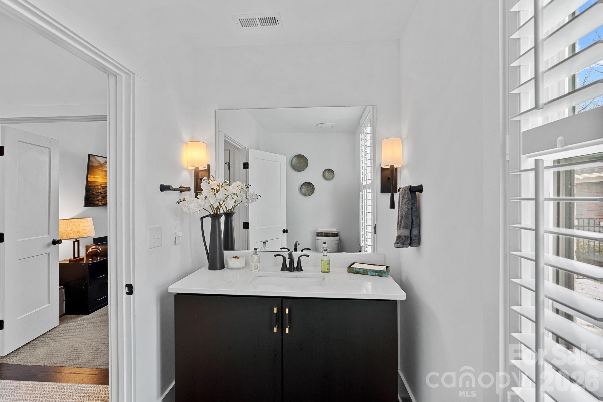 18401 Doves Crest Road Cornelius, NC 28031 - Photo 22 of 39 a bathroom with a sink and a mirror