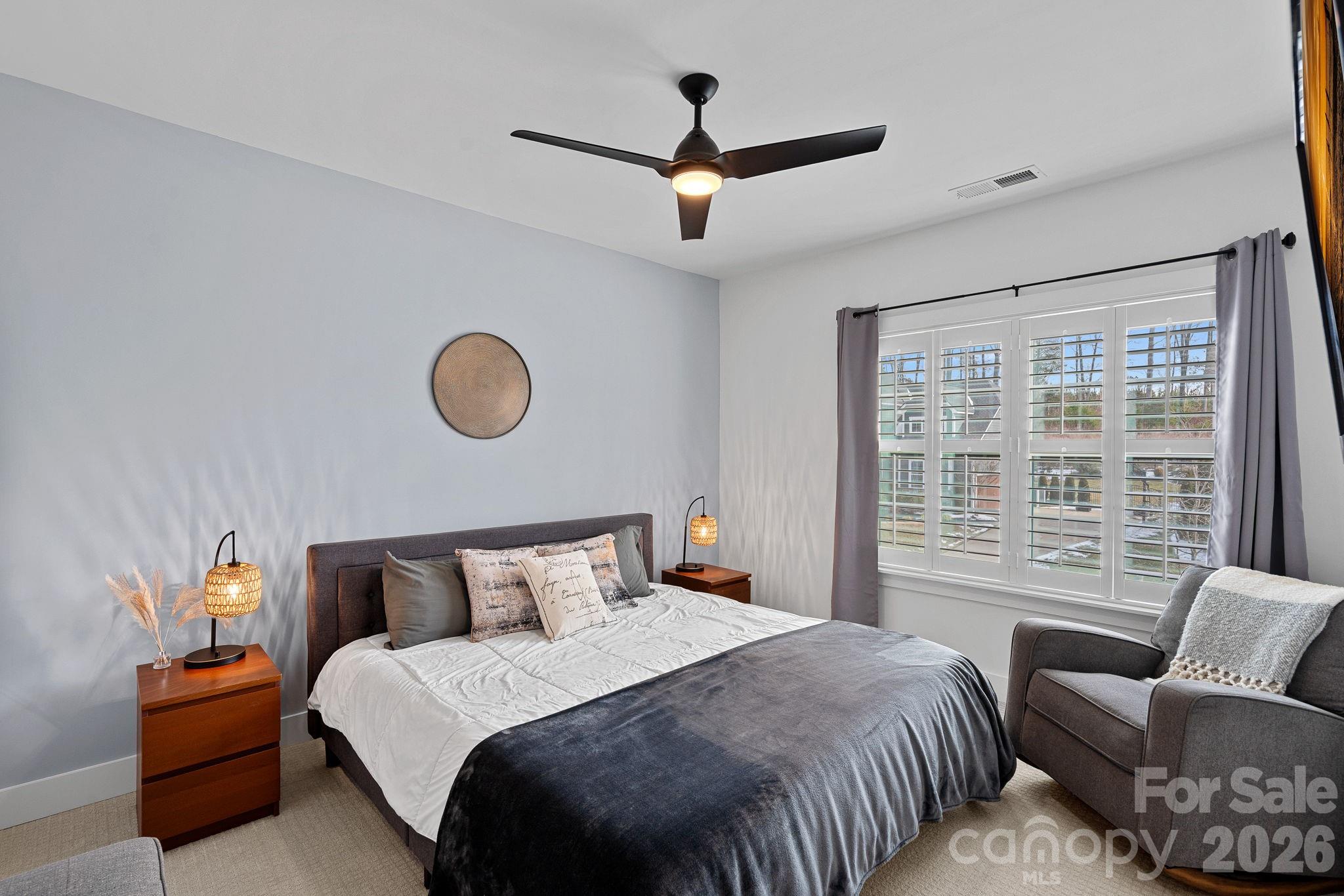 18401 Doves Crest Road Cornelius, NC 28031 - Photo 24 of 39 a bedroom with bed and a large window