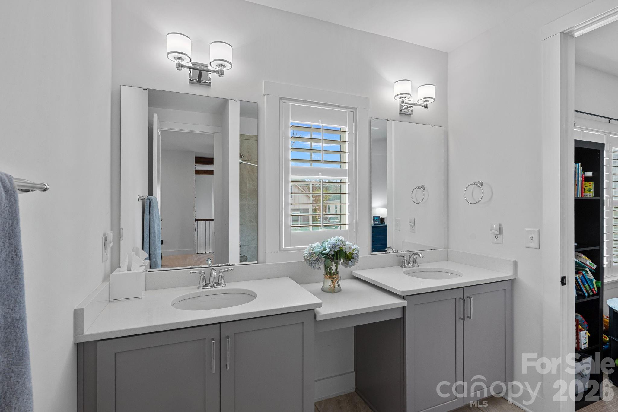 18401 Doves Crest Road Cornelius, NC 28031 - Photo 25 of 39 a bathroom with a sink double vanity and a mirror