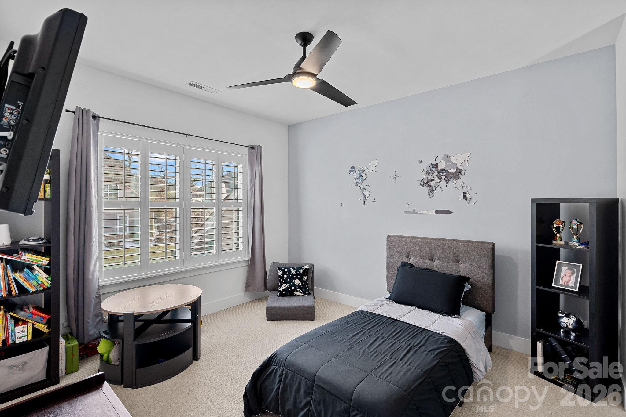 18401 Doves Crest Road Cornelius, NC 28031 - Photo 26 of 39 a bedroom with furniture and a fireplace