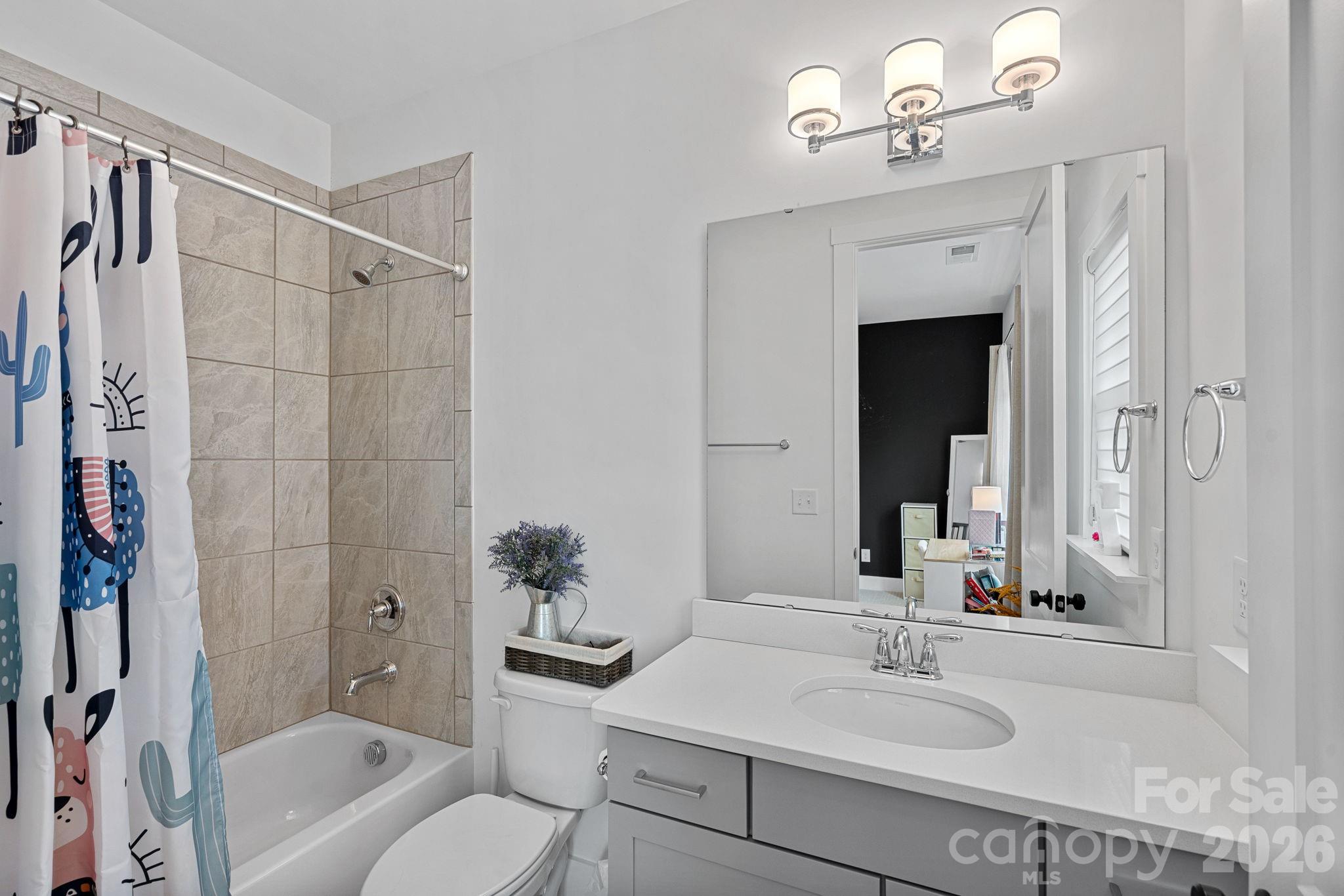 18401 Doves Crest Road Cornelius, NC 28031 - Photo 28 of 39 a bathroom with a sink a toilet and shower