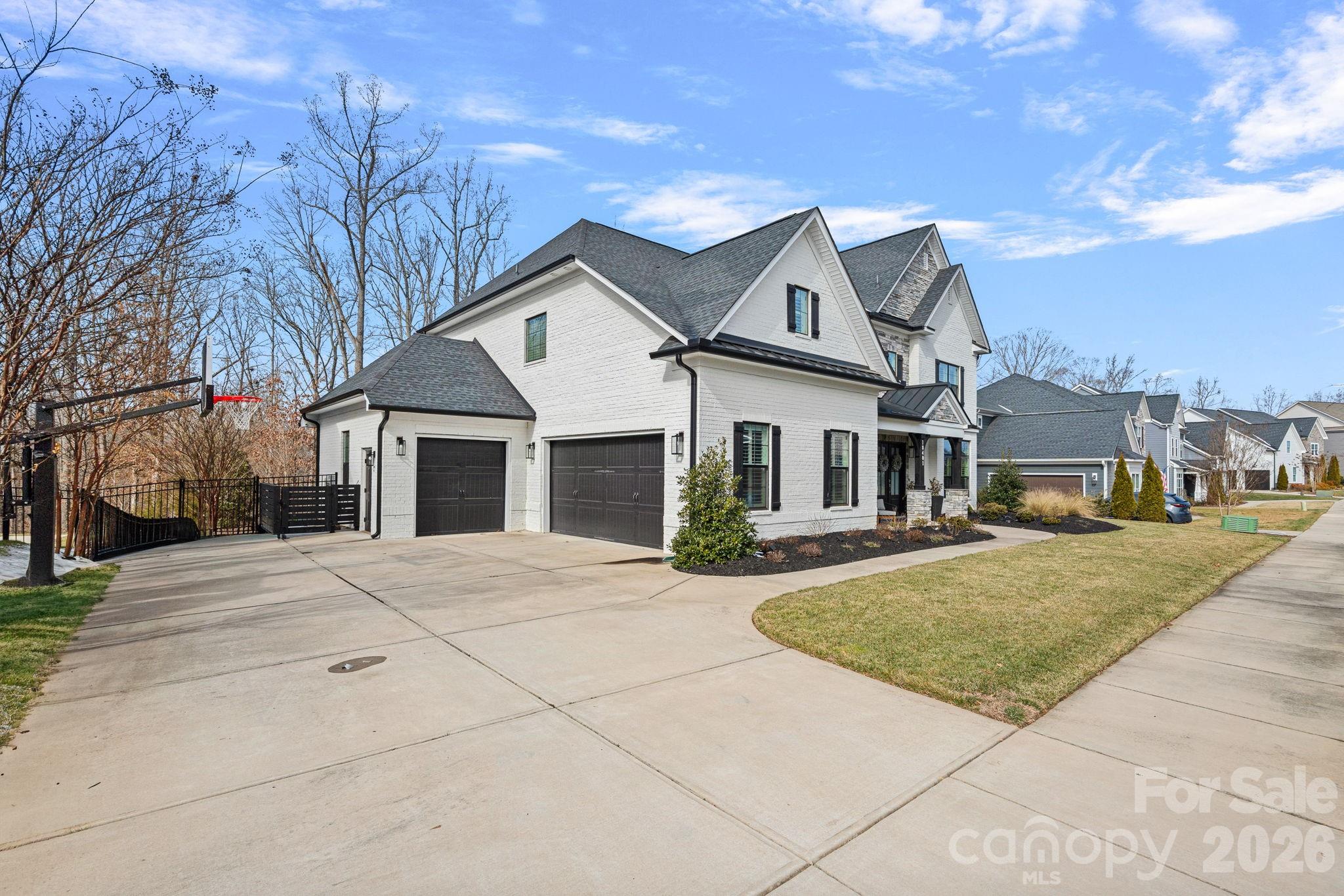 18401 Doves Crest Road Cornelius, NC 28031 - Photo 3 of 39 a front view of a house with a yard and garage
