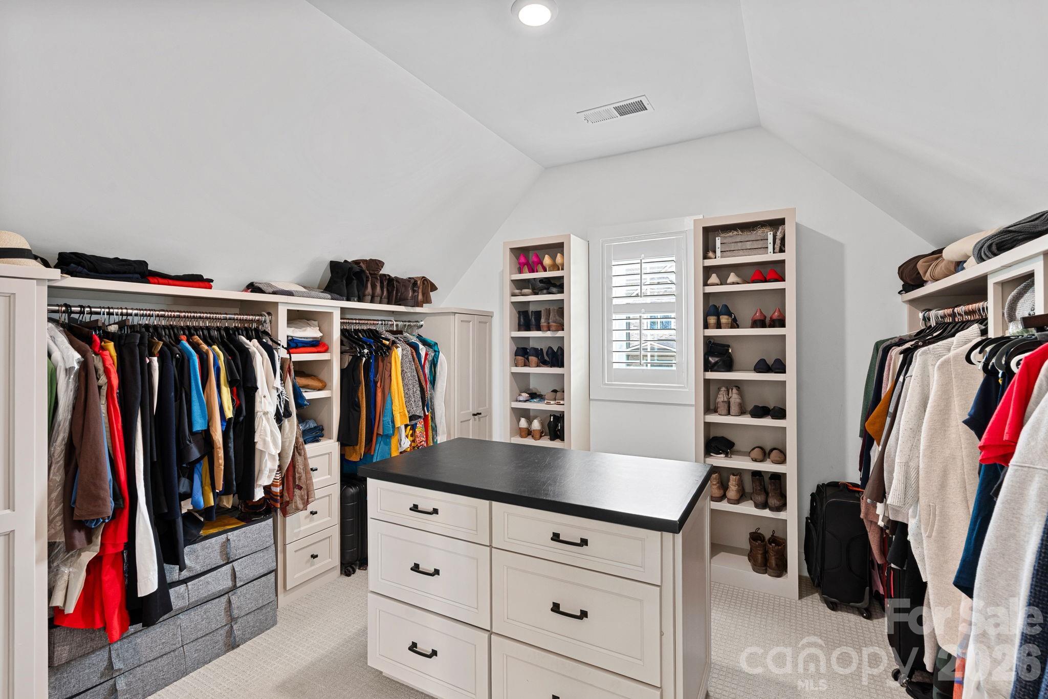 18401 Doves Crest Road Cornelius, NC 28031 - Photo 33 of 39 a view of walk in closet with clothes and shoes