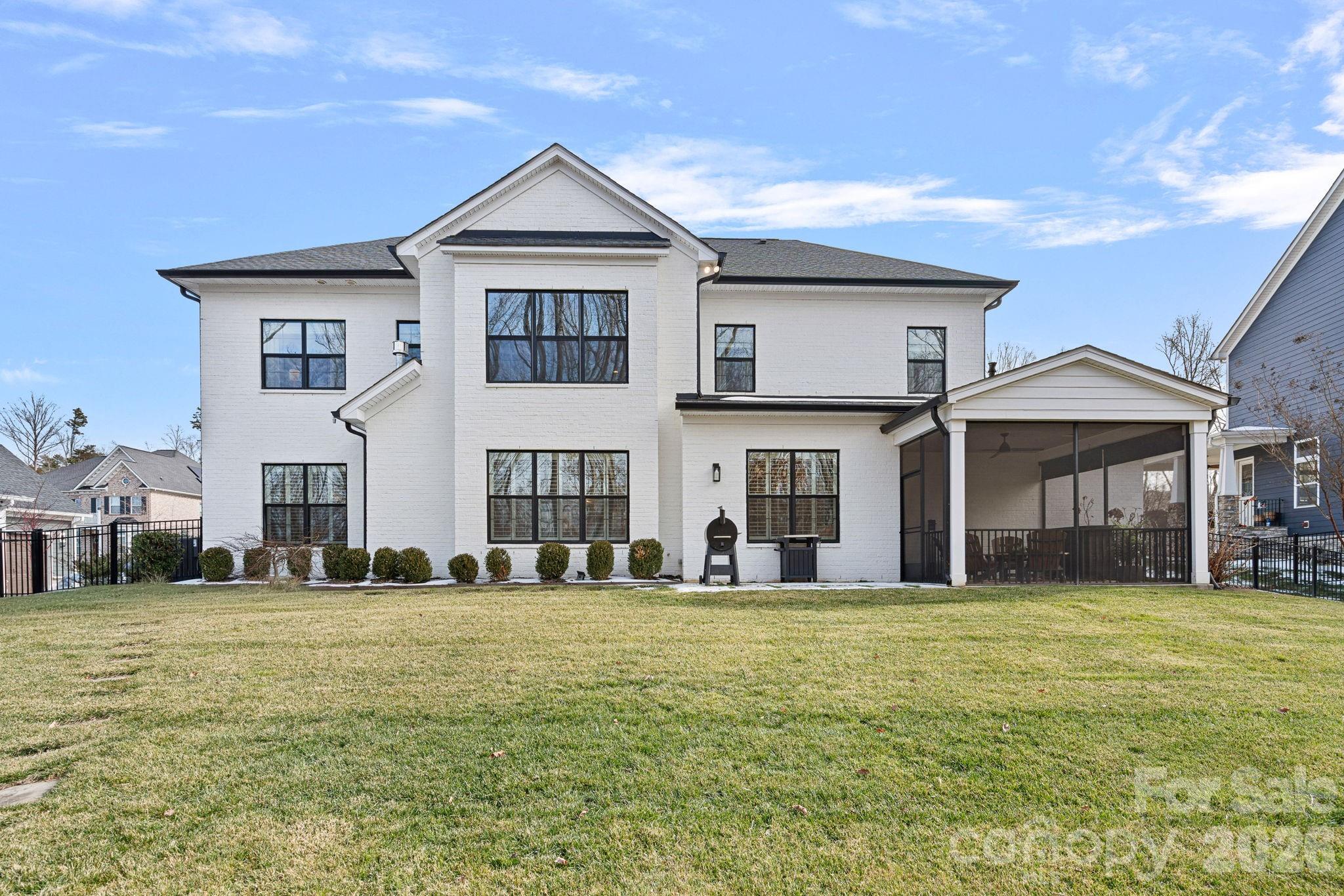 18401 Doves Crest Road Cornelius, NC 28031 - Photo 35 of 39 a view of a white house with a big yard and large trees