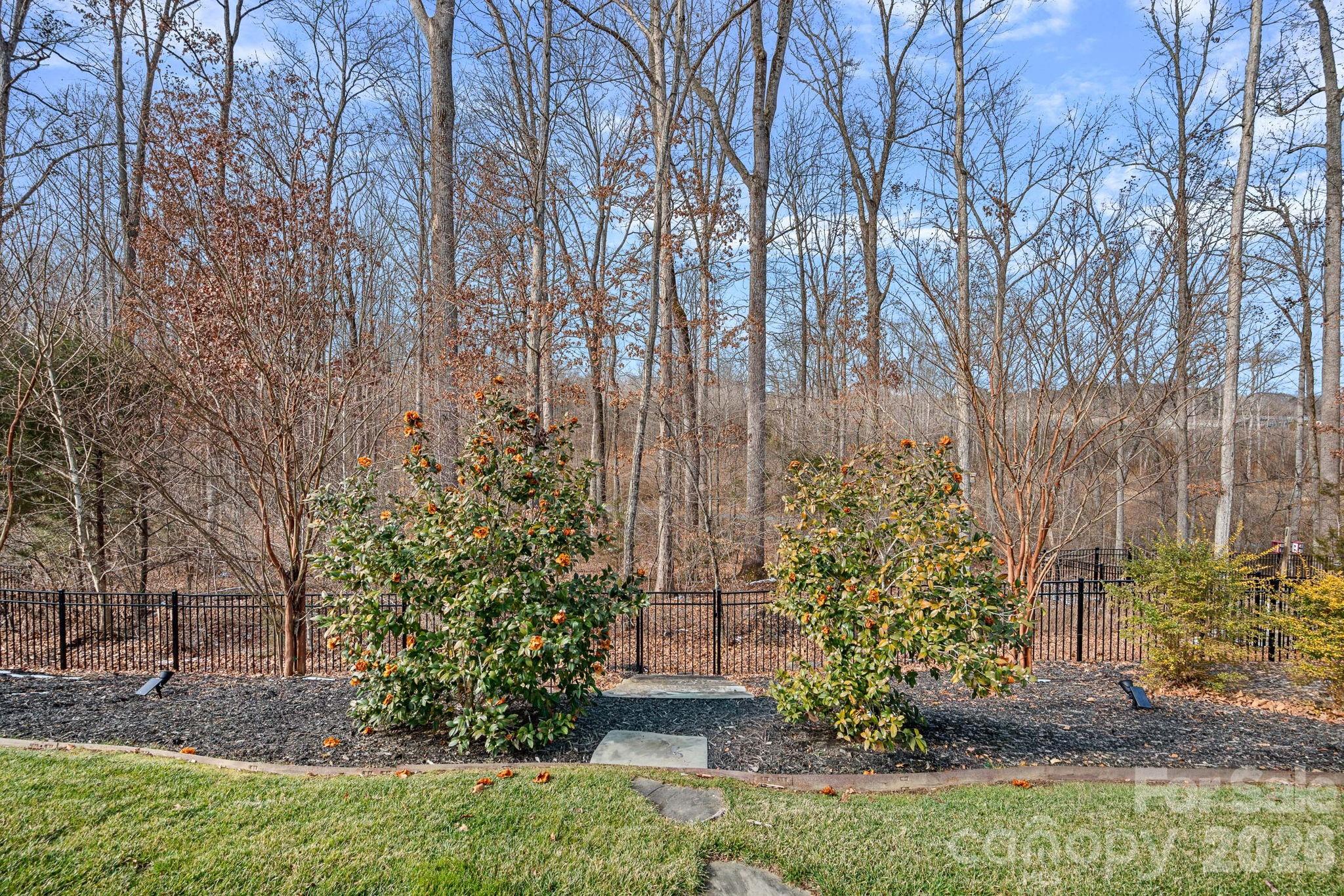 18401 Doves Crest Road Cornelius, NC 28031 - Photo 37 of 39 a view of a garden with a bench