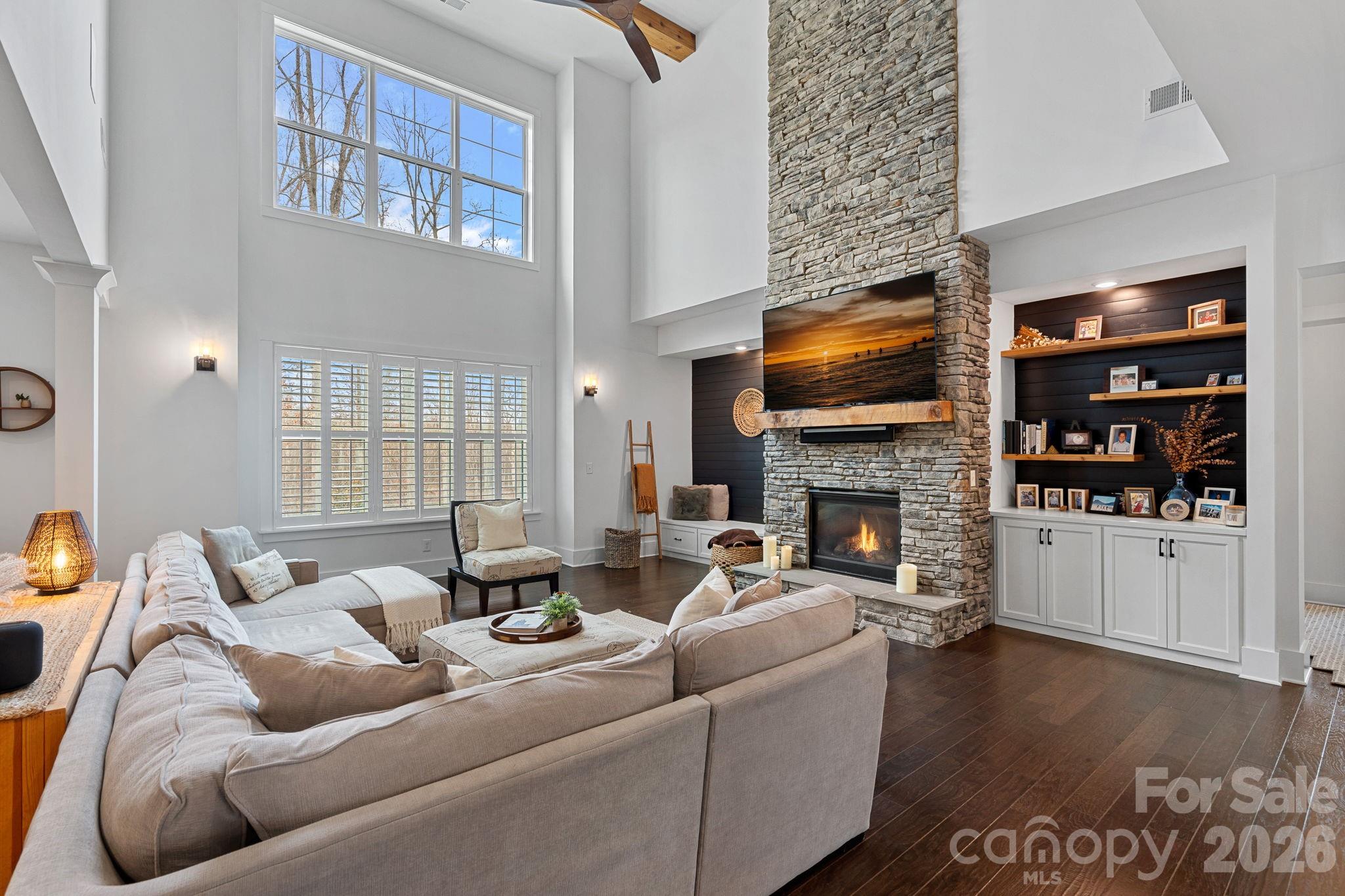 18401 Doves Crest Road Cornelius, NC 28031 - Photo 9 of 39 a living room with furniture fireplace and flat screen tv
