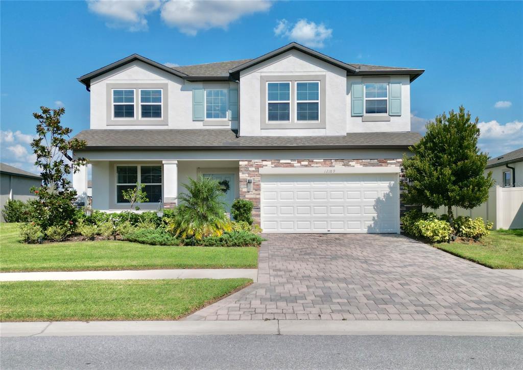 a front view of a house with a yard and garage