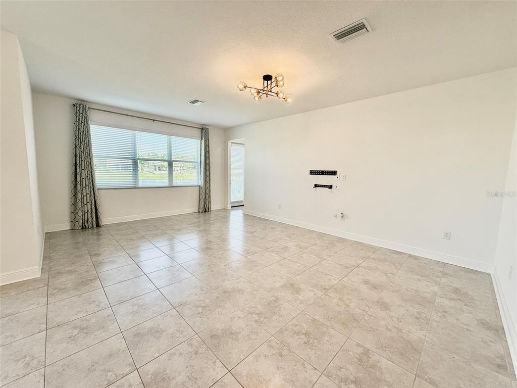 12189 Nouveau Avenue Spring Hill, FL 34610 - Photo 19 of 50 wooden floor in an empty room with a window