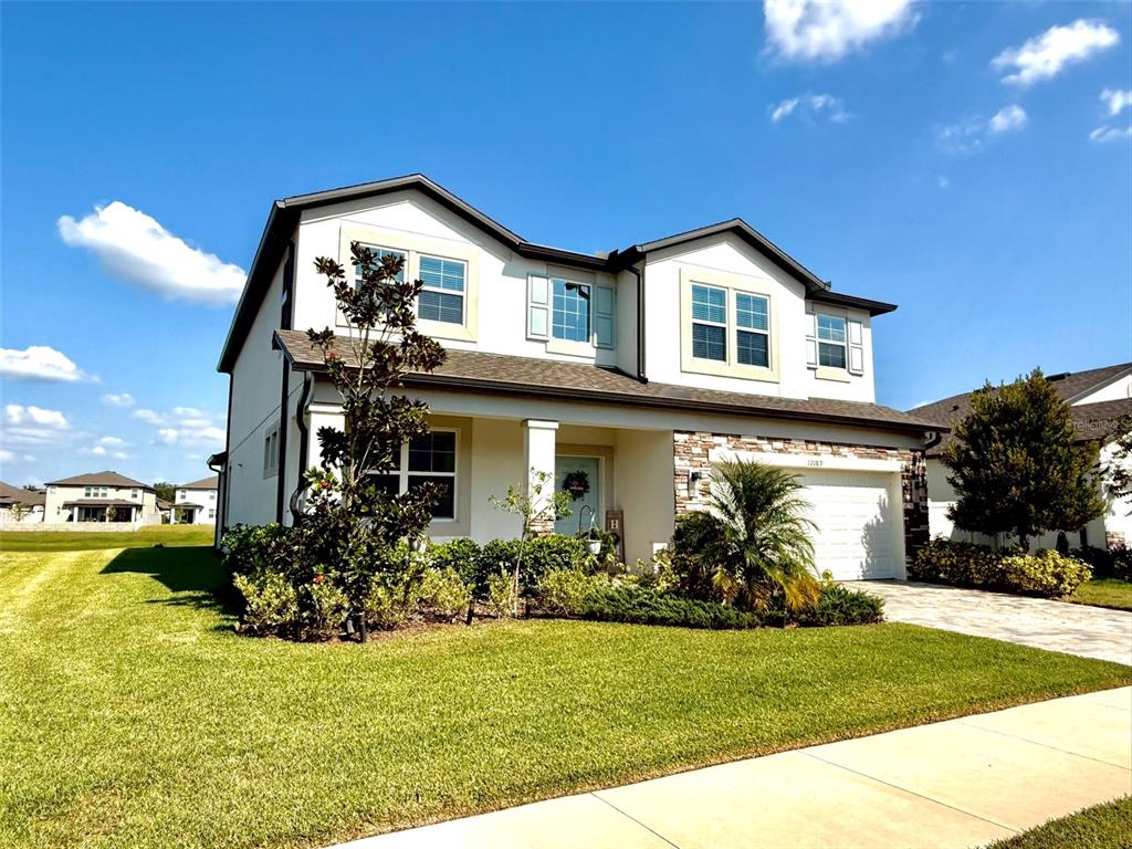 12189 Nouveau Avenue Spring Hill, FL 34610 - Photo 2 of 50 a front view of house with garden