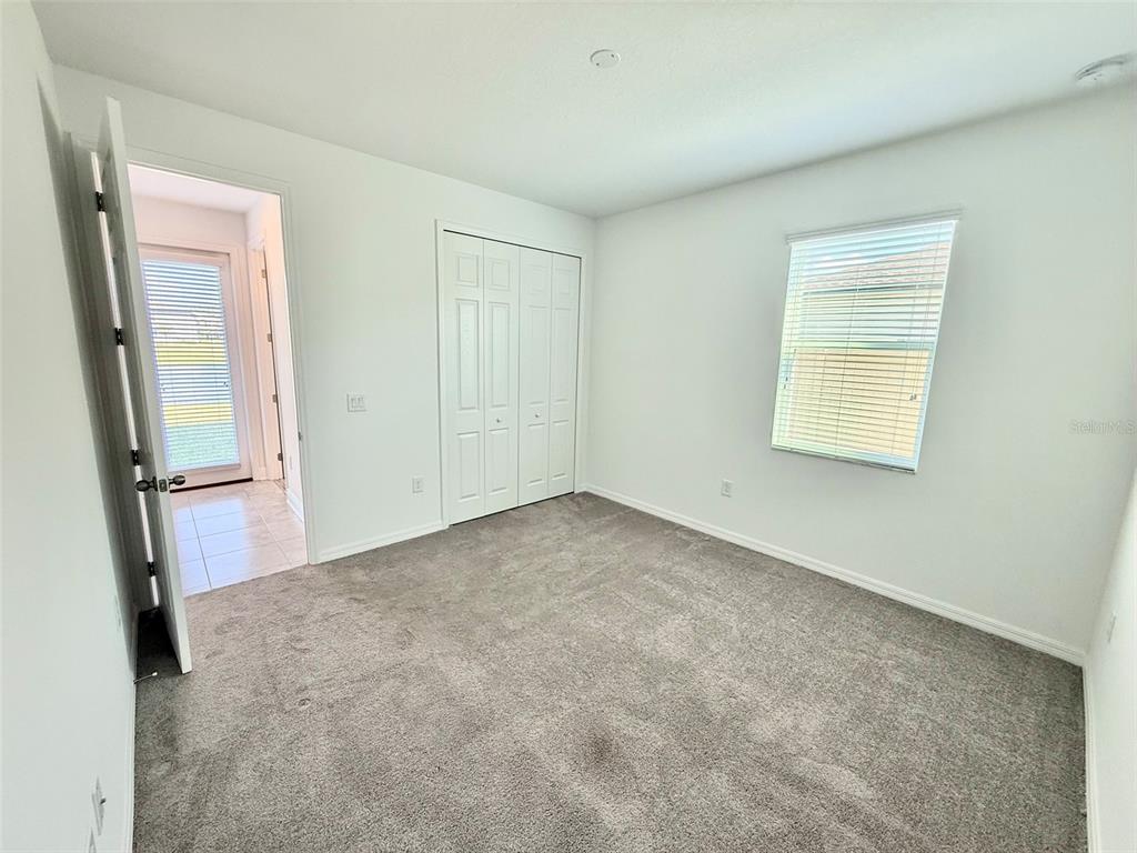 12189 Nouveau Avenue Spring Hill, FL 34610 - Photo 23 of 50 an empty room with closet and mirror