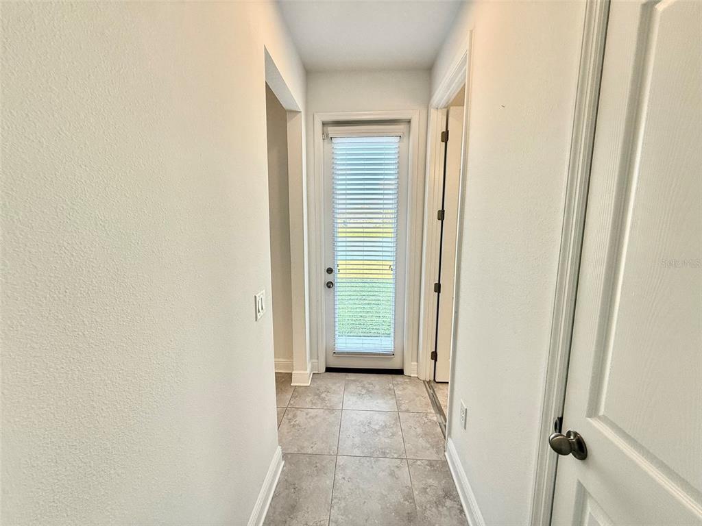 12189 Nouveau Avenue Spring Hill, FL 34610 - Photo 24 of 50 a view of a hallway with wooden floor