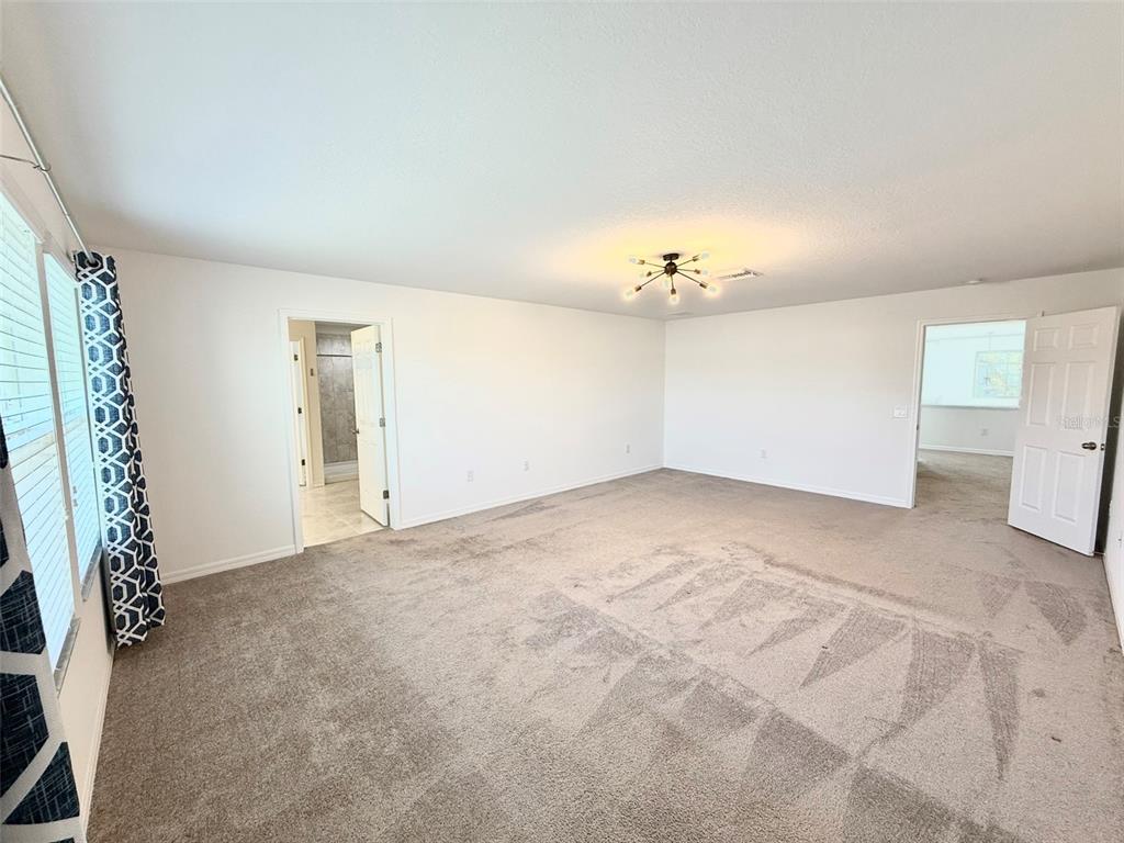 12189 Nouveau Avenue Spring Hill, FL 34610 - Photo 26 of 50 a view of an empty room with a window