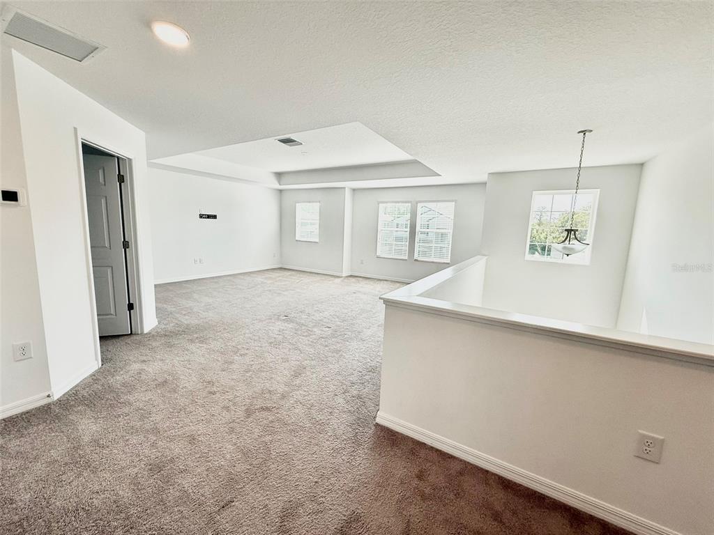 12189 Nouveau Avenue Spring Hill, FL 34610 - Photo 39 of 50 an empty room with a empty space and windows