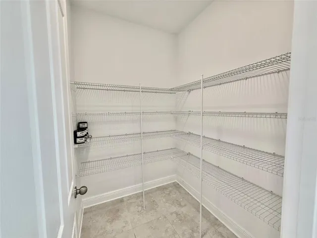 a view of a storage and utility room with a sink
