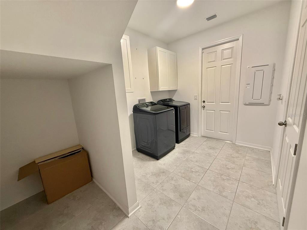 12189 Nouveau Avenue Spring Hill, FL 34610 - Photo 44 of 50 a kitchen with a refrigerator and window