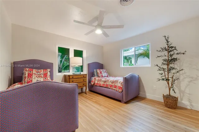 a bedroom with furniture and a wooden floor