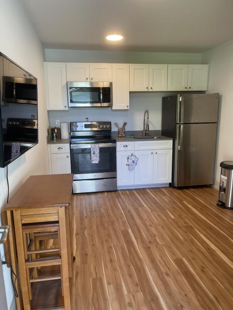 a kitchen with stainless steel appliances a refrigerator stove and microwave