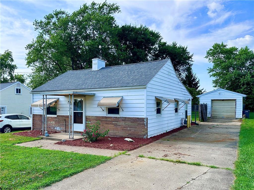 1920 Robinwood Street New Castle, PA 16101 - Photo 1 of 16 a front view of a house with a garden and plants