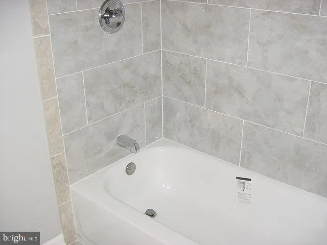 a white bath tub sitting in a bathroom