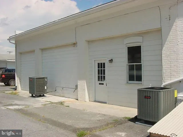 a view of a house with a wooden bench