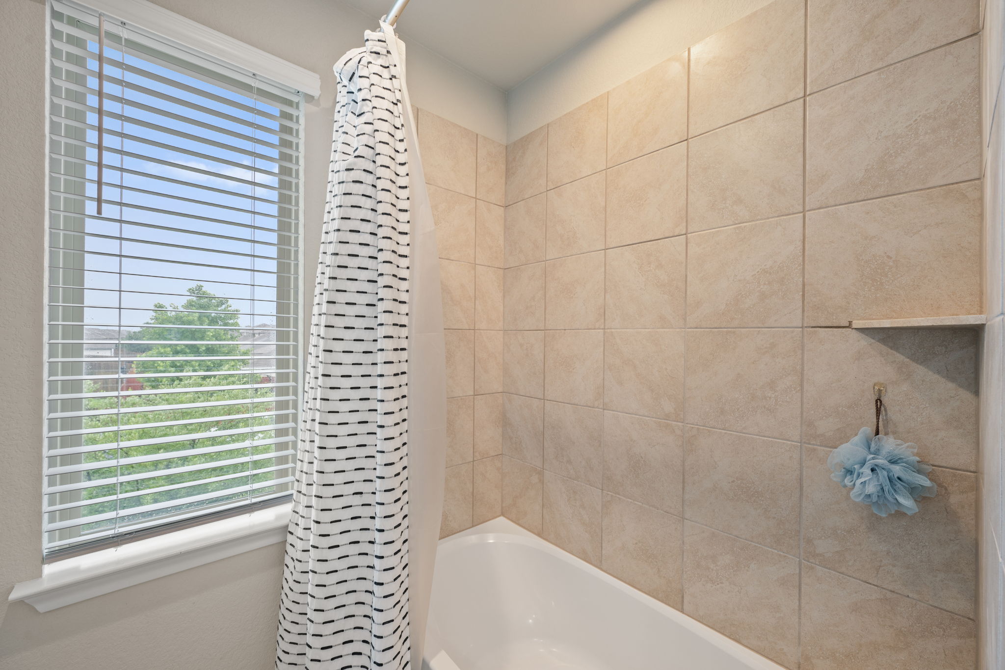 409 Limestone Road Liberty Hill, TX 78642 - Photo 27 of 35 a bathroom with a bathtub and shower