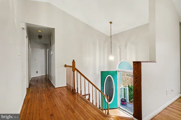 a view of entryway with furniture and wooden floor