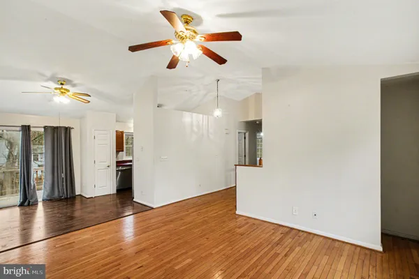 a view of an empty room with wooden floor