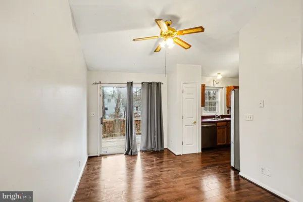 a view of a kitchen with a stove wooden floor and a ceiling fan