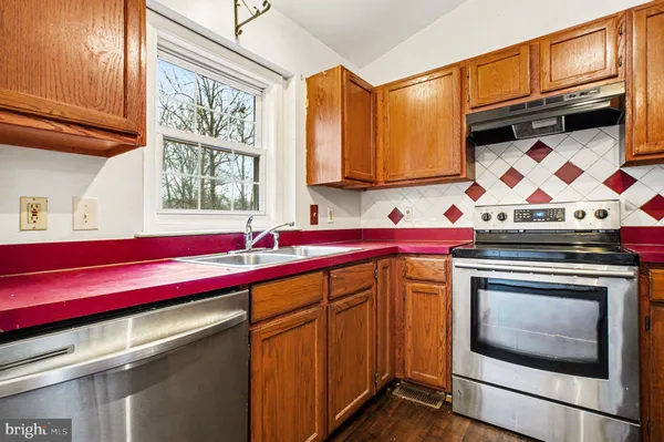a kitchen with stainless steel appliances granite countertop a sink and cabinets