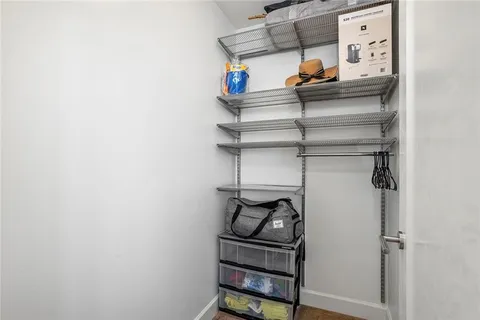a room with furniture a flat screen tv and a large window