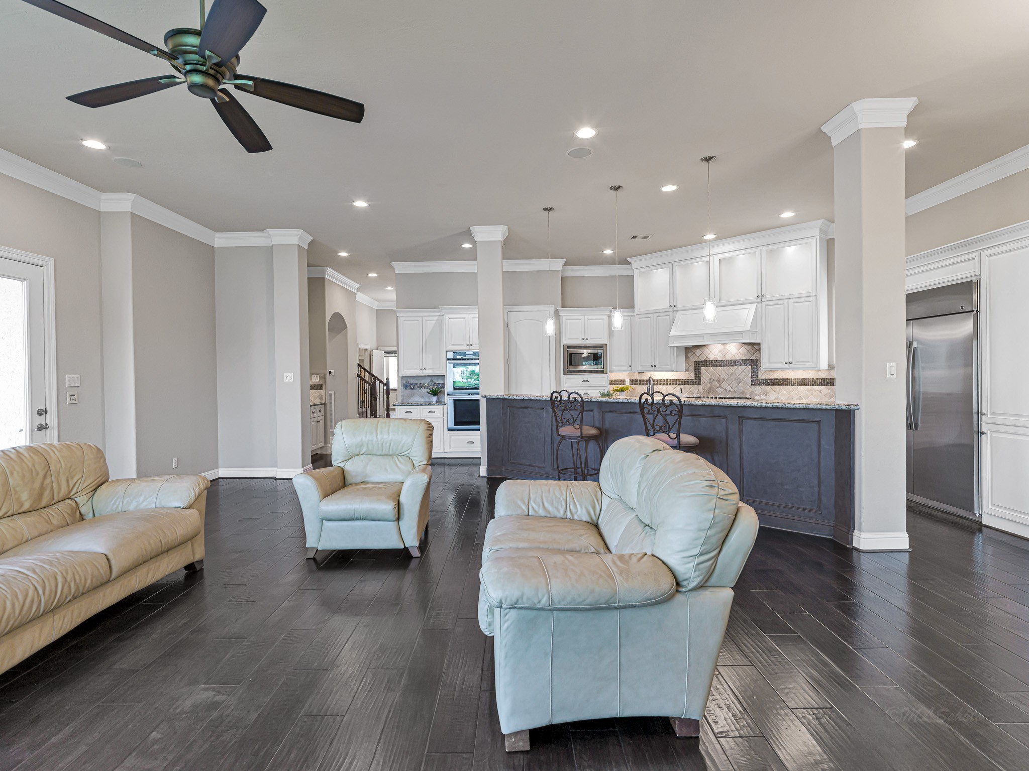1802 Sparrows Ridge Katy, TX 77450 - Photo 16 of 50 a living room with couches and kitchen view with wooden floor