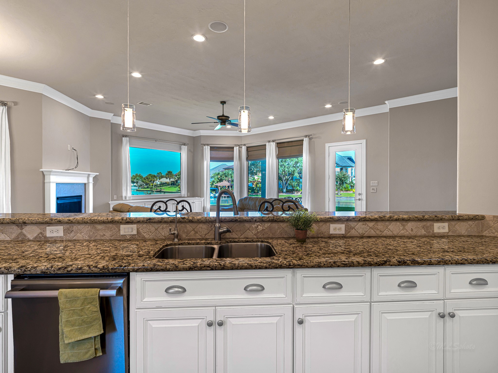 1802 Sparrows Ridge Katy, TX 77450 - Photo 20 of 50 a kitchen with granite countertop a sink and white cabinets