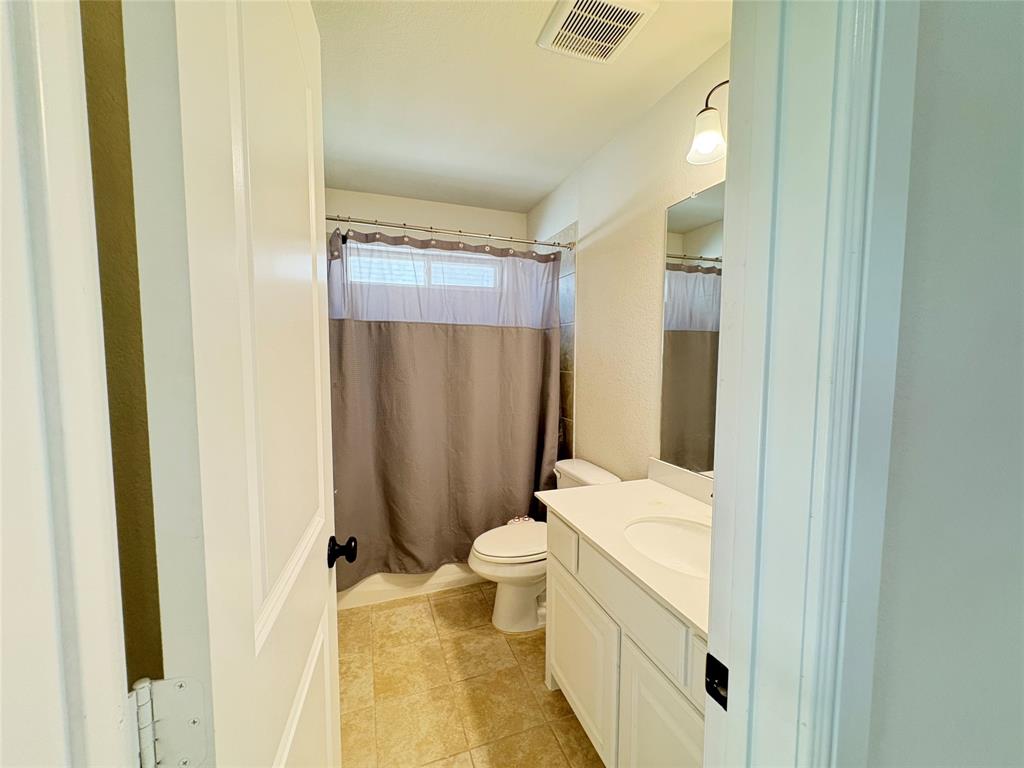 323 Butternut Way Irving, TX 75063 - Photo 28 of 32 a bathroom with a sink a toilet and shower