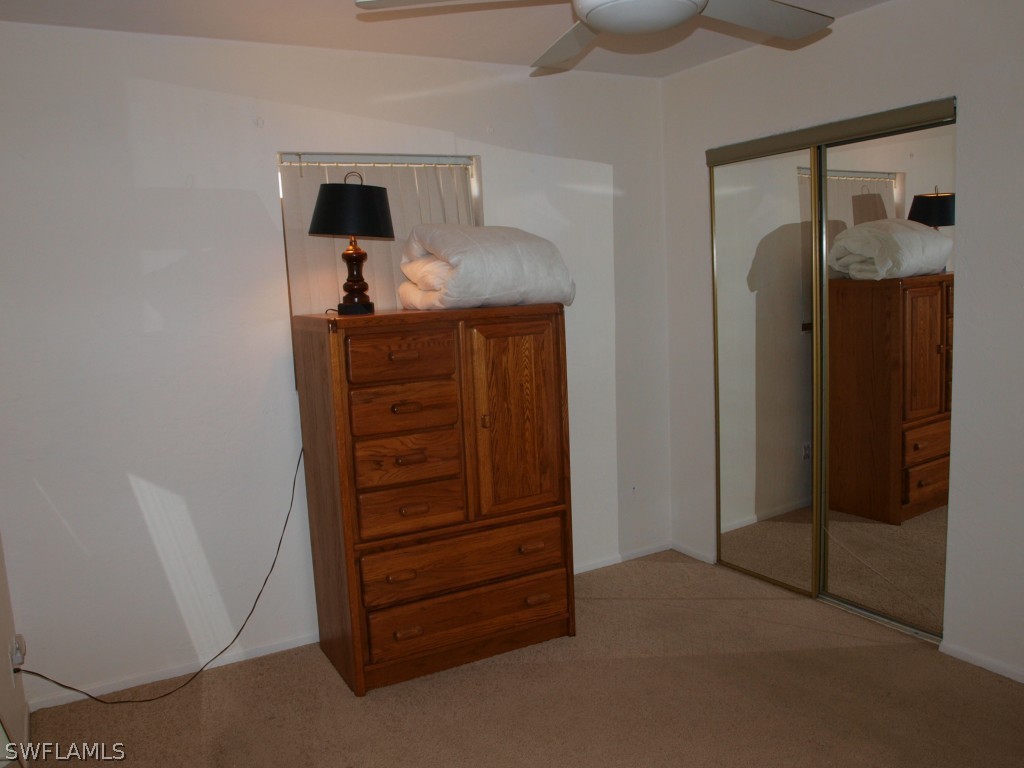 13034 First Street Fort Myers, FL 33905 - Photo 14 of 18 a room with a dresser and a mirror