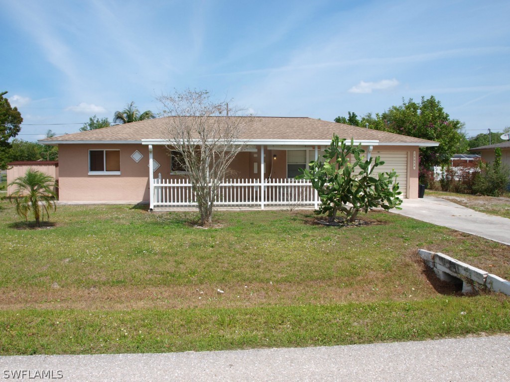 13034 First Street Fort Myers, FL 33905 - Photo 2 of 18 front view of a house with a yard