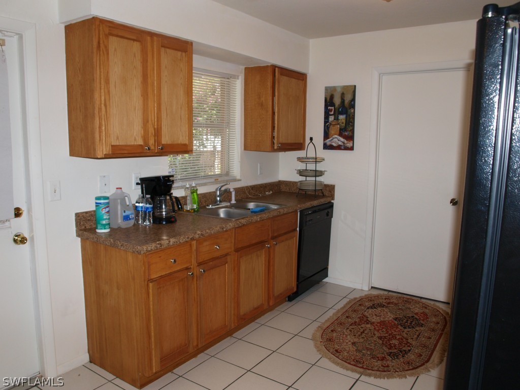 13034 First Street Fort Myers, FL 33905 - Photo 3 of 18 a kitchen with stainless steel appliances granite countertop a sink stove and refrigerator