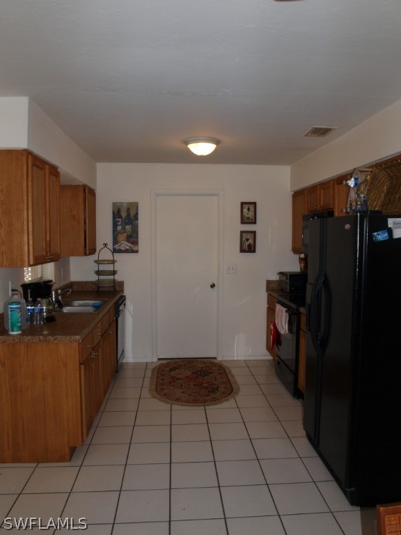 13034 First Street Fort Myers, FL 33905 - Photo 5 of 18 a kitchen with granite countertop a refrigerator and a stove top oven