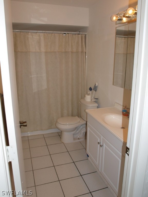 13034 First Street Fort Myers, FL 33905 - Photo 6 of 18 a bathroom with a granite countertop sink toilet and shower