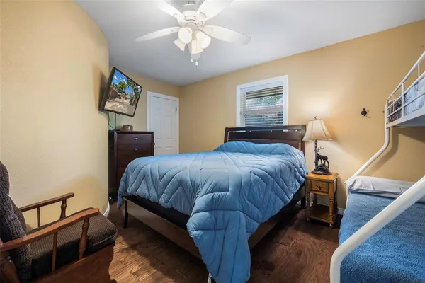 a bedroom with a bed and a chandelier