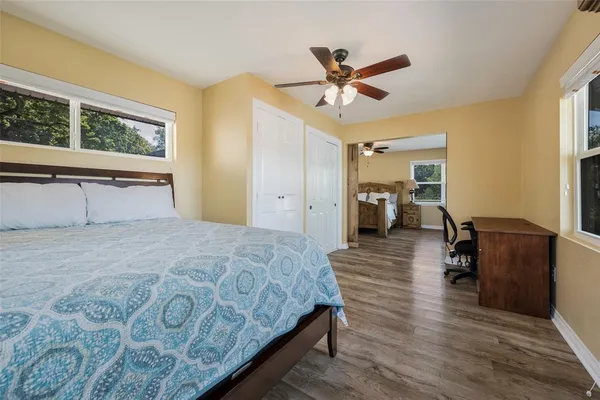 a bedroom with a bed and wooden floor
