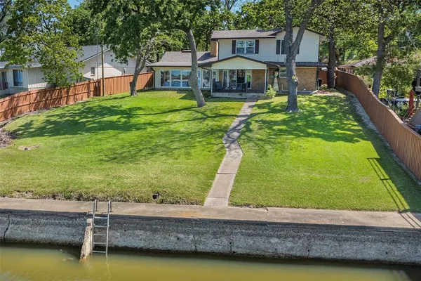 a view of a swimming pool with a patio and a yard