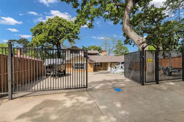 a view of a house with a small yard and wooden fence