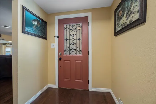 a view of a hallway with wooden floor and closet