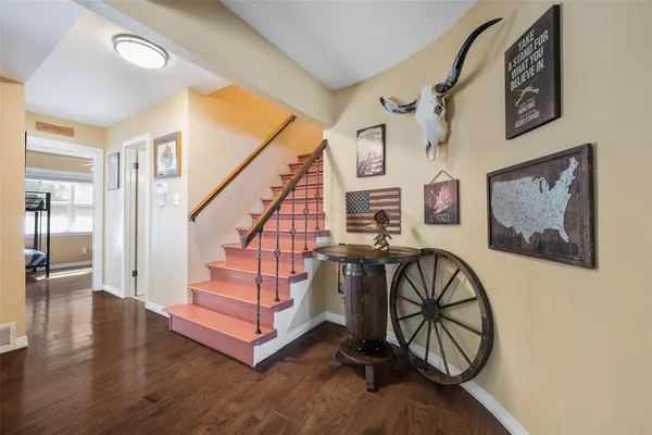 a view of an entryway with wooden floor