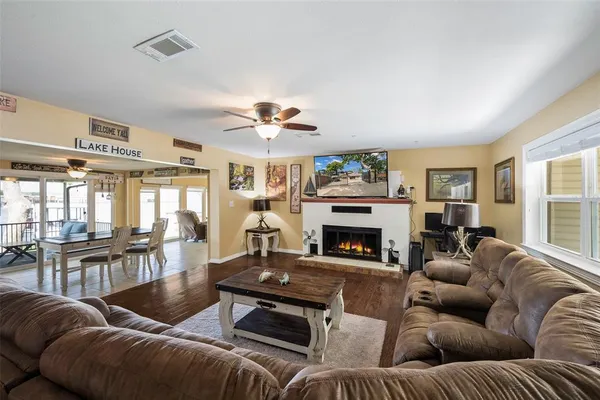 a living room with furniture fireplace and a large window